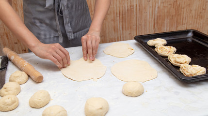 The hostess prepares the pies in the kitchen