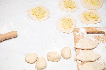 The hostess prepares the pies in the kitchen