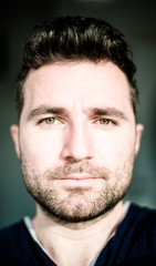 Obraz premium Portrait of Middle Aged Colored Eyed Stubble Handsome Man