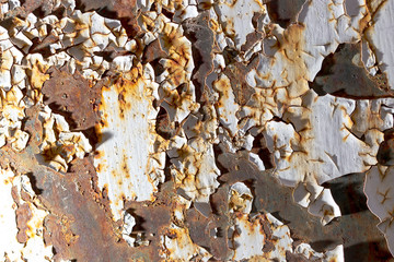 Cracked paint on rusty metal as abstract background