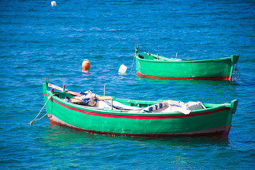 Naklejka na ściany i meble Beautiful old colored fishing wooden boats on the water
