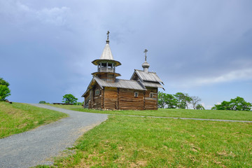 Scenic view of small wooden orthodox church on Kizhi island on Onezhsky lake in Russian Federation. Beautiful summer sunny look of traditional temple of russian North in Karelia