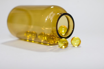yellow transparent round tablets in a transparent bottle
