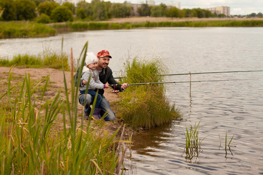 Dad And Daughter Fishing On Lake