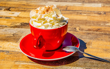 A red cup of cappuccino 