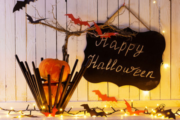 Halloween decorations on wooden background in home
