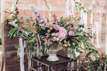 Obraz na płótnie Canvas Wedding asymmetrical stylish bouquet with purple roses
