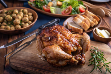 dinning image with whole grilled chicken and salad