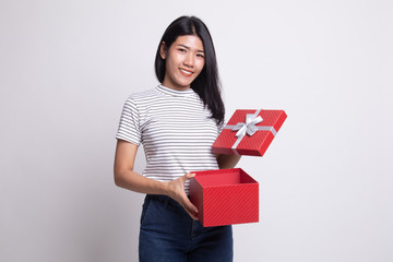 Young Asian woman open a golden gift box.