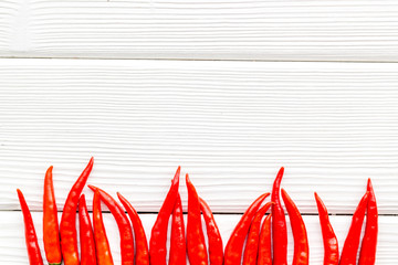 Fresh red chilli pepper pattern on white wooden table background top view space for text