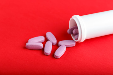 pink pills poured out of jars