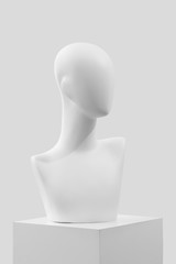 Mannequin on a white catwalk. Fashionable mannequin without eyes and mouth. Mannequin on a light background. 