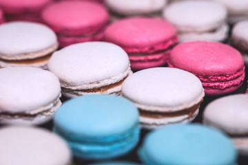 Close up colorful macarons dessert vintage pastel blue and pink tones, union jack pattern, 4th July celebration or french flag full frame background with copy space