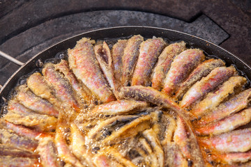 Fresh striped red mullets frying