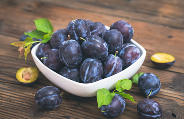Fresh organic plums in the bowl 