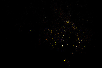 Golden abstract bokeh on black background. Holiday concept