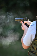 Outdoor target shooting with a 9mm pistol in a shooting range