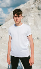 Handsome model man wearing white blank t-shirt with space for your logo or design.