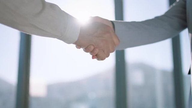 close up business people shaking hands successful corporate partnership deal welcoming opportunity for cooperation in office 4k footage