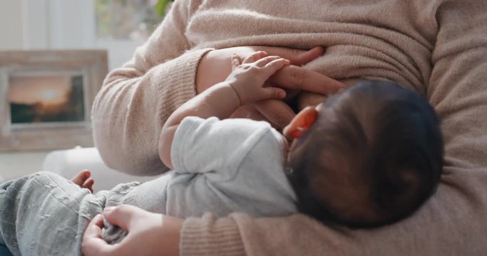 mother breastfeeding baby at home nursing infant mom enjoying motherhood childcare 4k