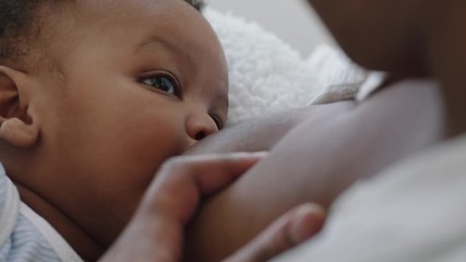 mother breastfeeding baby at home mom nursing infant nurturing child suckling milk from breast motherhood maternity care