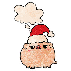 cartoon pig wearing christmas hat and thought bubble in grunge texture pattern style