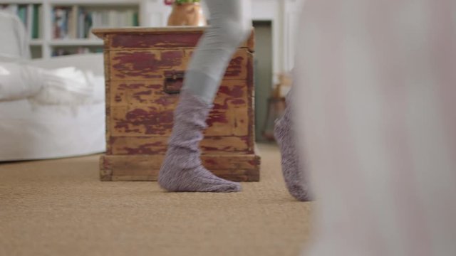 close up feet happy woman dancing at home having fun celebrating weekend morning with funky dance moves wearing socks enjoying freedom 4k footage
