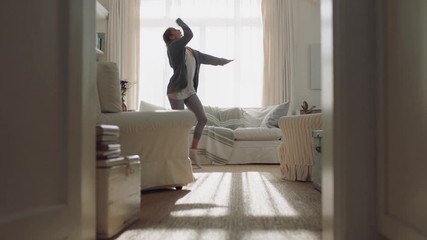 happy young woman dancing at home having fun celebrating with funny dance moves enjoying freedom on weekend morning 4k footage