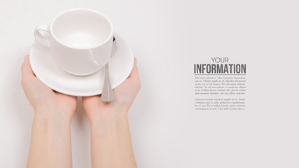 White saucer cup in hand, sample text on white background isolation
