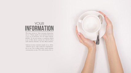 White saucer cup in hand, sample text on white background isolation