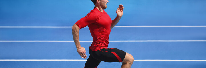 Athlete runner man sprinting in red compression top on run race track panorama. Horizontal banner...