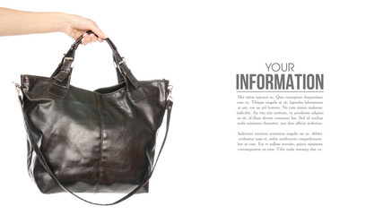 Fototapeta na wymiar Female black brown leather bag in hand, sample text on white background isolation
