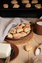Homemade sugar cookies on ceramic plate and in the oven. Ingredients for cookies - sugar, butter