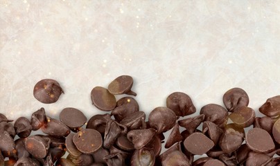 Pile of chocolate candies on gray background