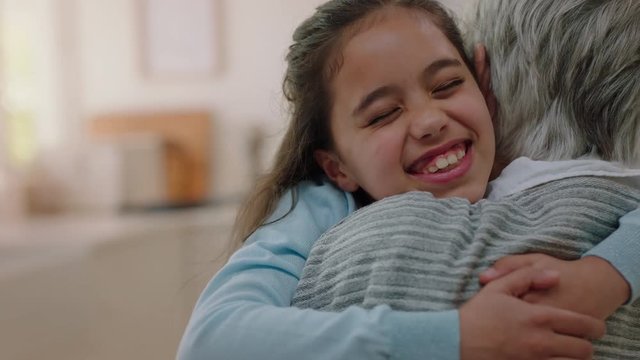 happy little girl hugging grandmother smiling embracing granddaughter loving granny enjoying affection at home family concept 4k footage