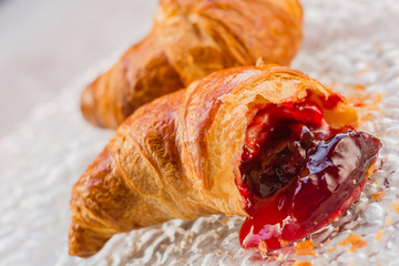 Beautiful croissant with jam on plate