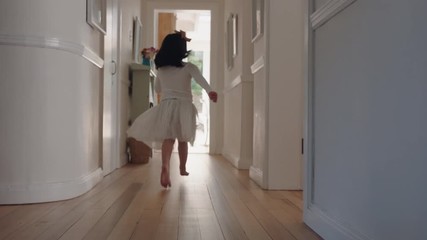 happy little girl running through house wearing tutu excited to play outside child having fun on weekend morning enjoying childhood 4k footage