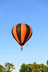 Colorful hot air balloon on the background blue sky.