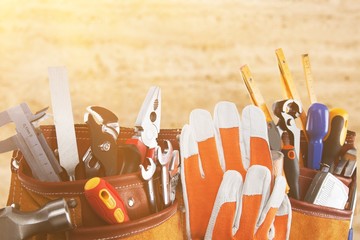 Gloves and tools on wooden background
