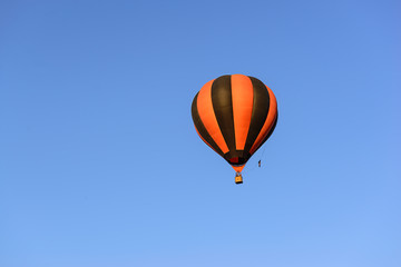 Colorful hot air balloon on the background blue sky.