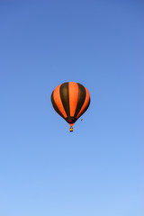 Colorful hot air balloon on the background blue sky.
