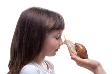 Attractive little girl is holding a Akhatina snail. Isolated on white background. Close up. Concept of youth and beauty skin, facial rejuvenation