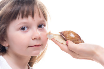 Attractive little girl is holding a Akhatina snail. Isolated on white background. Close up. Concept of youth and beauty skin, facial rejuvenation