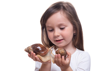 Attractive little girl is holding a Akhatina snail. Isolated on white background. Close up. Concept of youth and beauty skin, facial rejuvenation