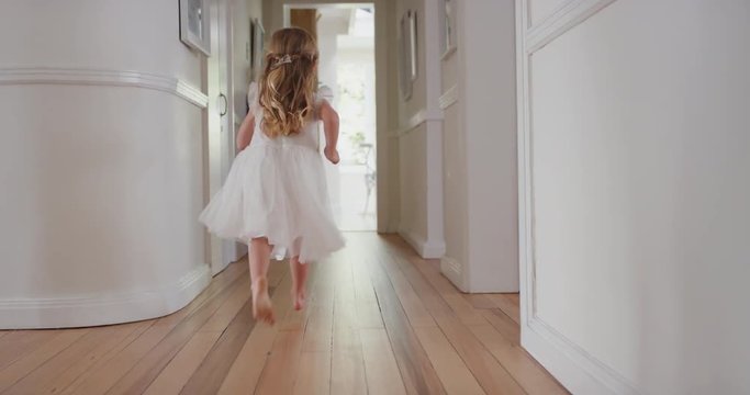 happy little girl running through house wearing excited to play outside child having fun on weekend morning enjoying wearing pretty white dress 4k