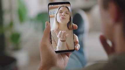 young man having video chat using smartphone chatting to girlfriend on screen enjoying conversation sharing lifestyle on mobile phone long distance relationship vertical orientation 4k - Powered by Adobe