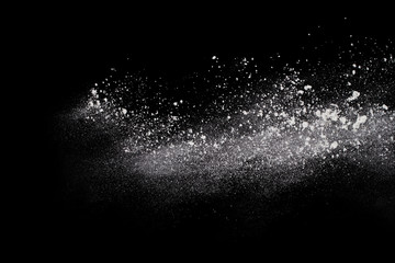 White powder explosion on black background. Colored cloud. Colorful dust explode. Paint Holi.