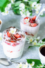 Cottage cheese dessert with strawberries on the background of flowers and coffee