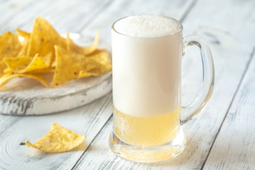 Mug of beer with tortilla chips