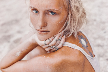 Fototapeta na wymiar beautiful young fashion model on the beach. Close up portrait of boho model